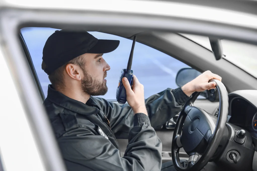 Man talking into a walkie talkie while on patrol
